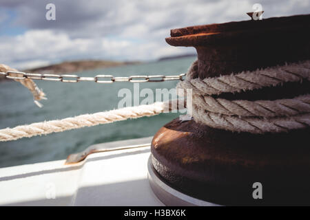 Rope tied to bollard on boat deck Stock Photo