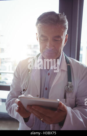 Doctor with stethoscope using digital tablet Stock Photo