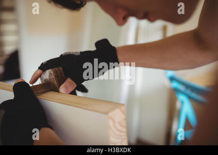 Carpenter using marking gauge on a wooden door Stock Photo