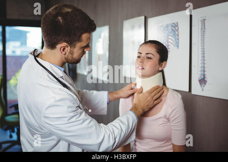 Physiotherapist examining a female patient's neck Stock Photo