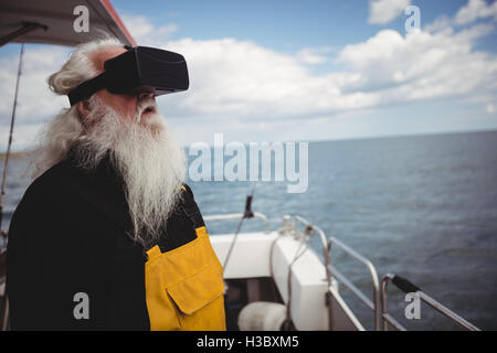 Fisherman using virtual reality glasses Stock Photo