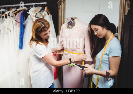 Female fashion designer working on a tablet Stock Photo