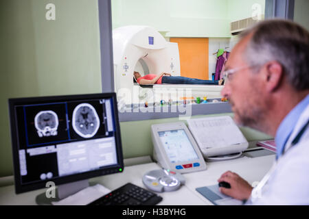 Doctor examining brain mri scan on computer Stock Photo