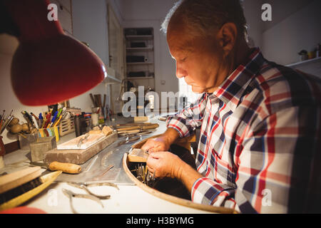 Goldsmith shaping metal with pilers Stock Photo