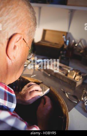 Goldsmith working in workshop Stock Photo