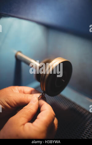Goldsmith polishing ring in workshop Stock Photo
