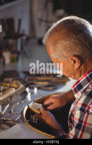 Goldsmith shaping metal with pilers Stock Photo