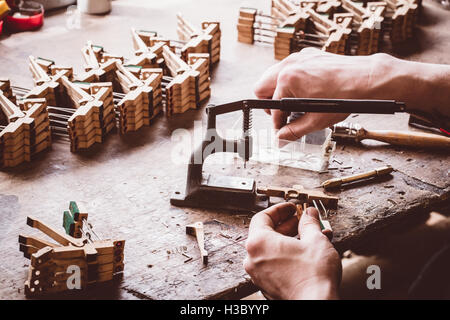 Piano technician working on piano parts Stock Photo