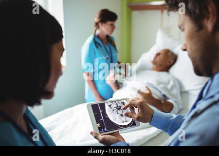 Male doctor and nurse using digital tablet Stock Photo