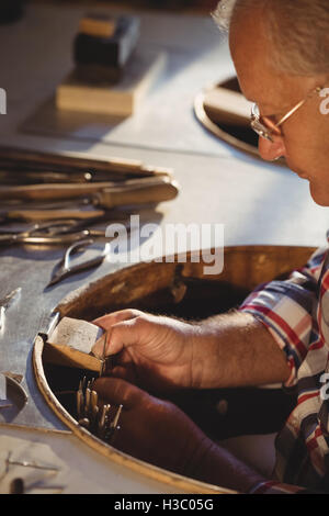 Goldsmith working in workshop Stock Photo