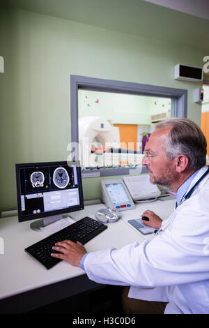 Doctor examining brain mri scan on computer Stock Photo