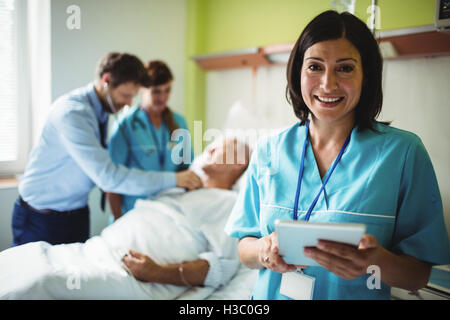 Nurse using digital tablet Stock Photo