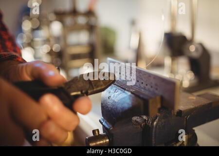 Goldsmith working in workshop Stock Photo