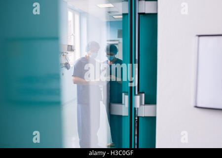 Surgeons discussing over digital tablet Stock Photo