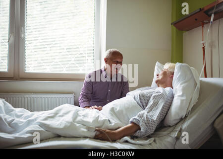 Senior man consoling senior woman Stock Photo