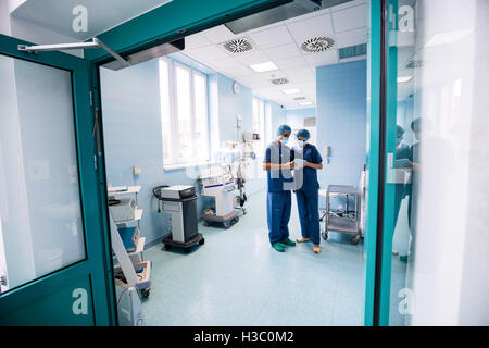 Surgeons discussing over digital tablet Stock Photo
