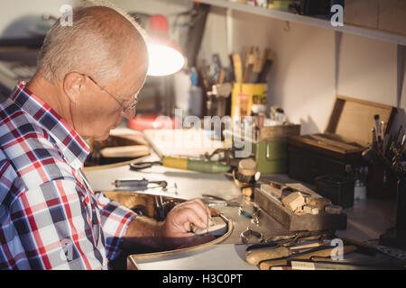 Goldsmith working in workshop Stock Photo