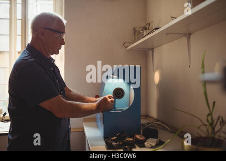 Goldsmith polishing ring in workshop Stock Photo