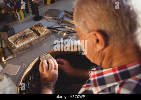 Goldsmith working in workshop Stock Photo