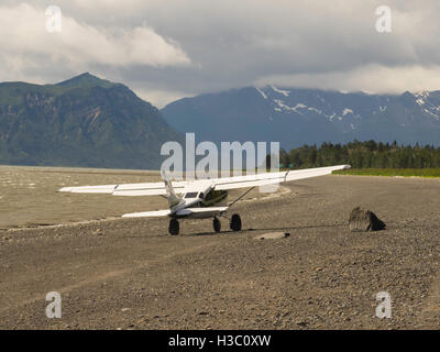 A bush plane takes off from the shore of Chinitna Bay, Lake Clark National Park, Alaska. Stock Photo