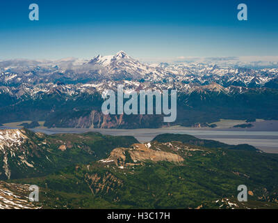 Aerial view of the Redoubt Volcano, shrouded in the clouds, with Tuxedni Bay in the foreground, Lake Clark National Park, Alaska Stock Photo