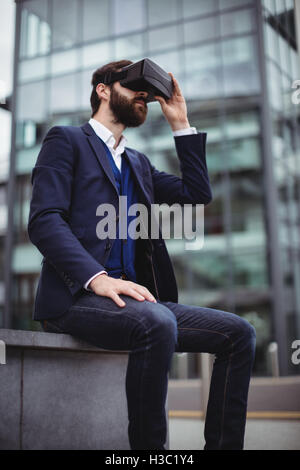 Businessman using virtual reality headset Stock Photo