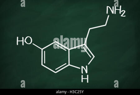 Structural model of Serotonin on the blackboard. Stock Photo