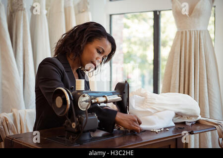 Fashion designer sewing in the studio Stock Photo