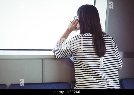 Rear view of woman talking on mobile phone Stock Photo