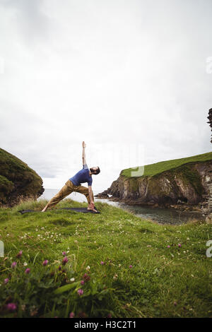 Man performing stretching exercise Stock Photo