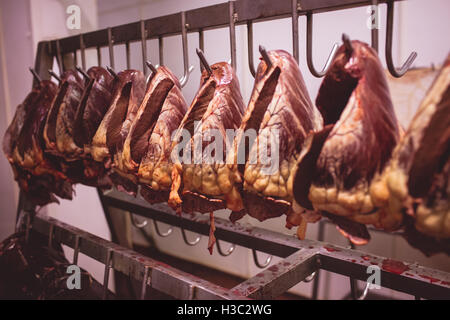 Heart of beef hanging in a row in storage room Stock Photo