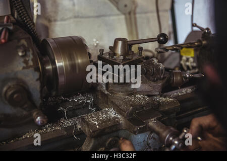 Mechanic working on a lathe machine Stock Photo