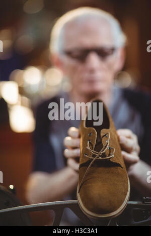 Shoemaker using sewing machine Stock Photo