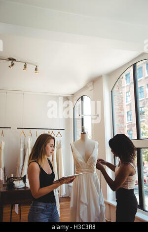 Female fashion designers working on a digital tablet Stock Photo