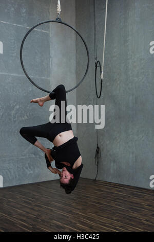 Gymnast performing gymnastics on hoop Stock Photo