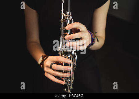 Woman playing a clarinet in music school Stock Photo