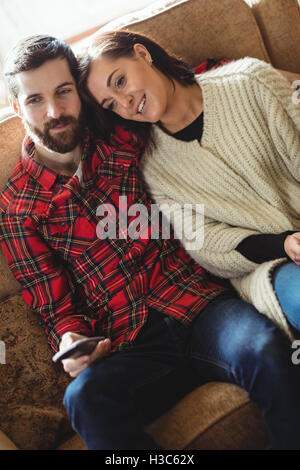 Beautiful Couple Watching Tv Sitting On Couch At Home Stock Photo - Alamy