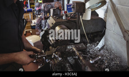 Mechanic working on a lathe machine Stock Photo