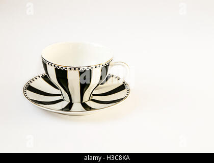 A beautiful black and white striped cup and saucer isolated on white. Stock Photo