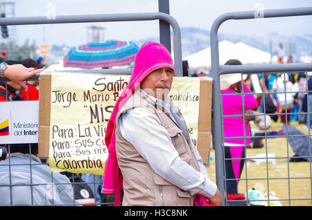 QUITO, ECUADOR - JULY 7, 2015: Man looking to the camera, covered by pink sweater on his head, pope Francisco mass Stock Photo