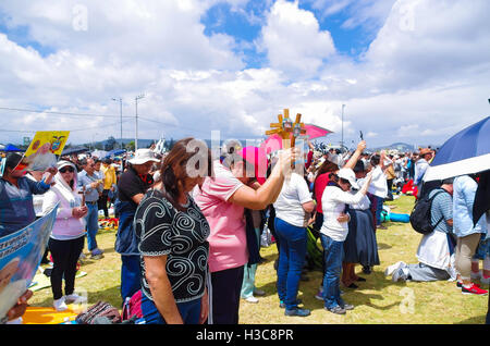 QUITO, ECUADOR - JULY 7, 2015: People praying and raising their crosses to receive blessings, pope Francisco mass Stock Photo