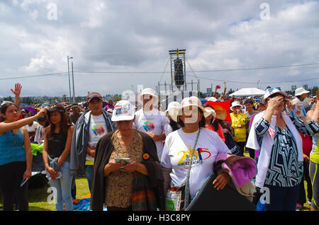 QUITO, ECUADOR - JULY 7, 2015: Unidentified people praying in pope mass event, persons with hat under the sun Stock Photo