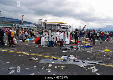 QUITO, ECUADOR - JULY 7, 2015: Huge place where pope Francisco mass event was, people still in the rain. Garbage on the floor Stock Photo