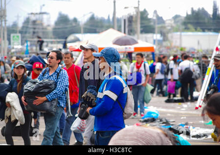 QUITO, ECUADOR - JULY 7, 2015: Several focus on men, garbage cleaner after pope Francisco mass event in Quito Stock Photo