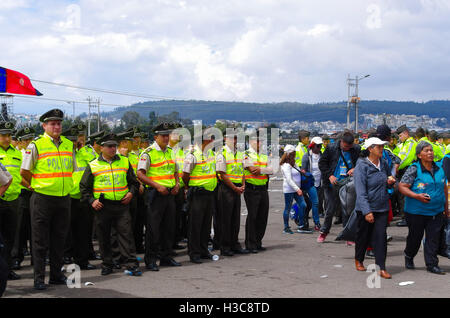 QUITO, ECUADOR - JULY 7, 2015: After the event, people getting out of the place and police guarding them untill the end Stock Photo