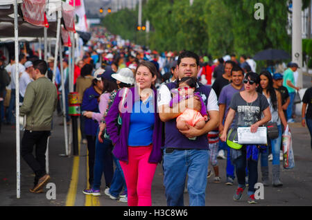 QUITO, ECUADOR - JULY 7, 2015: Family walking on the street, mother, father and little child want to see pope Francisco Stock Photo