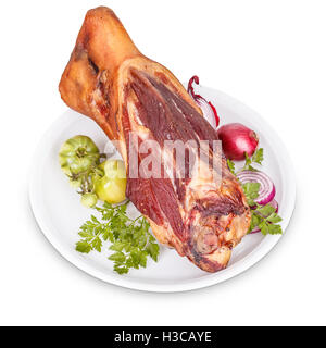 Smoked pork knuckle with onion on white plate Stock Photo