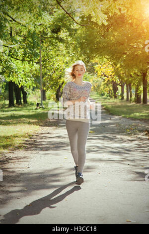 Young girl with blue eyes a joging in the park Stock Photo