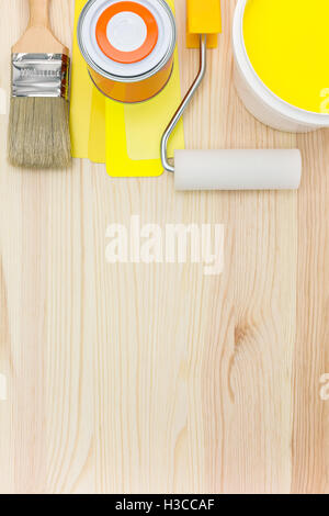 brush, roller with paint can and color samples on wooden background Stock Photo