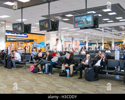 People sitting and waiting on Fort Lauderdale Hollywood International Airport in Florida, USA Stock Photo